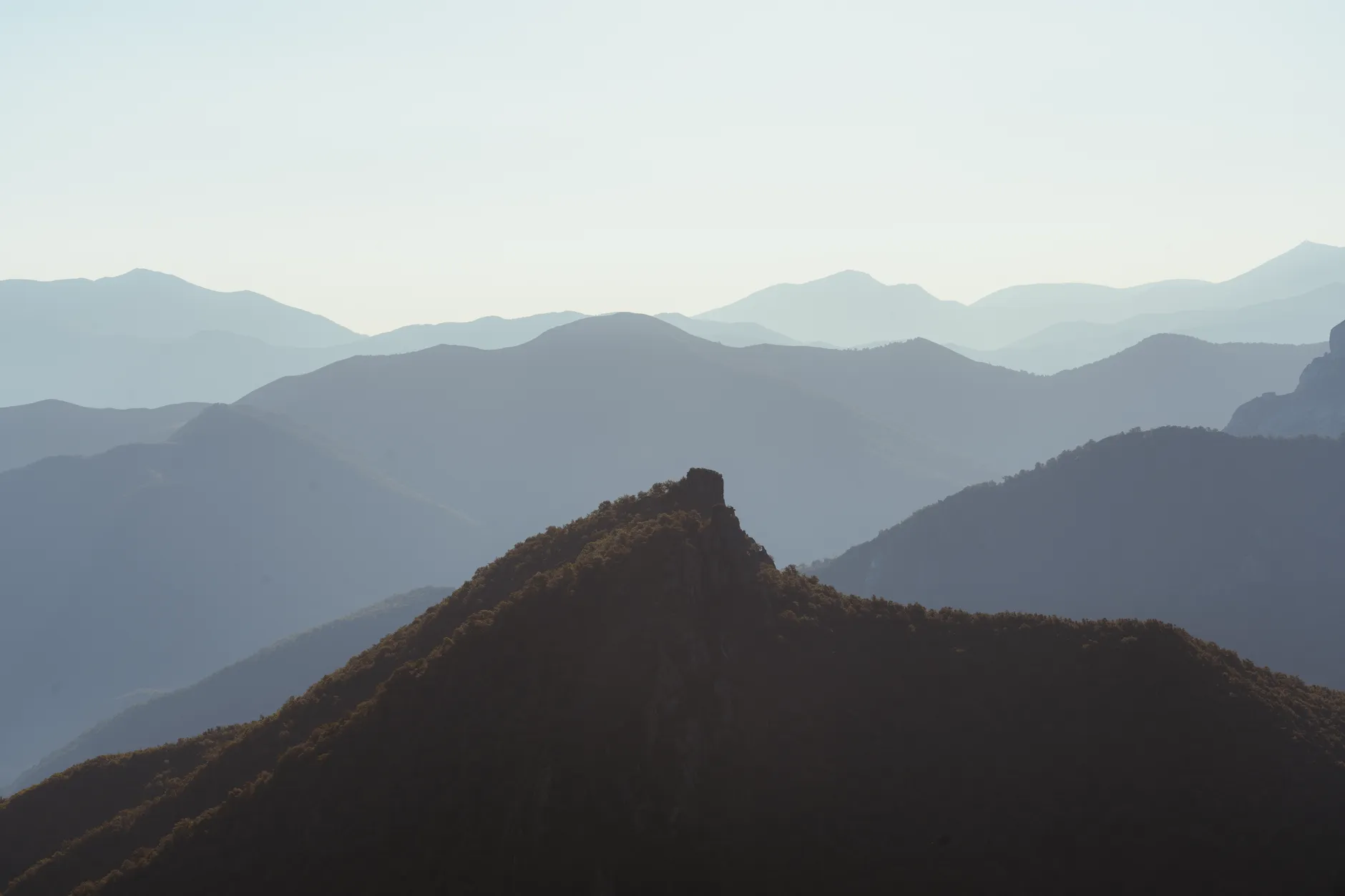 Layers of mountain ridges fading into morning haze